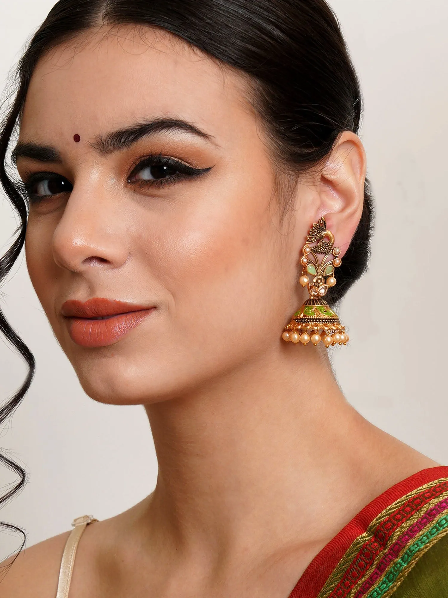 Karatcart Gold Plated Light Green Stone Studded Peacock Shape Jhumki Earrings for Women