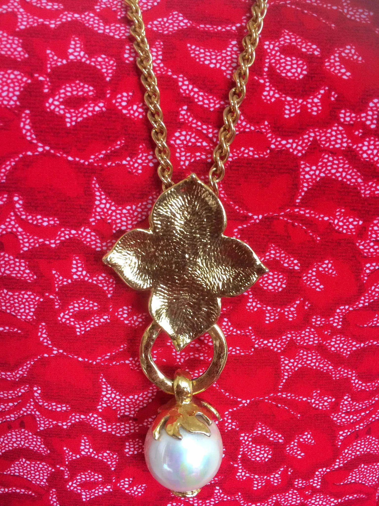 MINT. Vintage Yves Saint Laurent golden chain long statement necklace with extra large faux pearl and flower petal pendant top. Opal shine