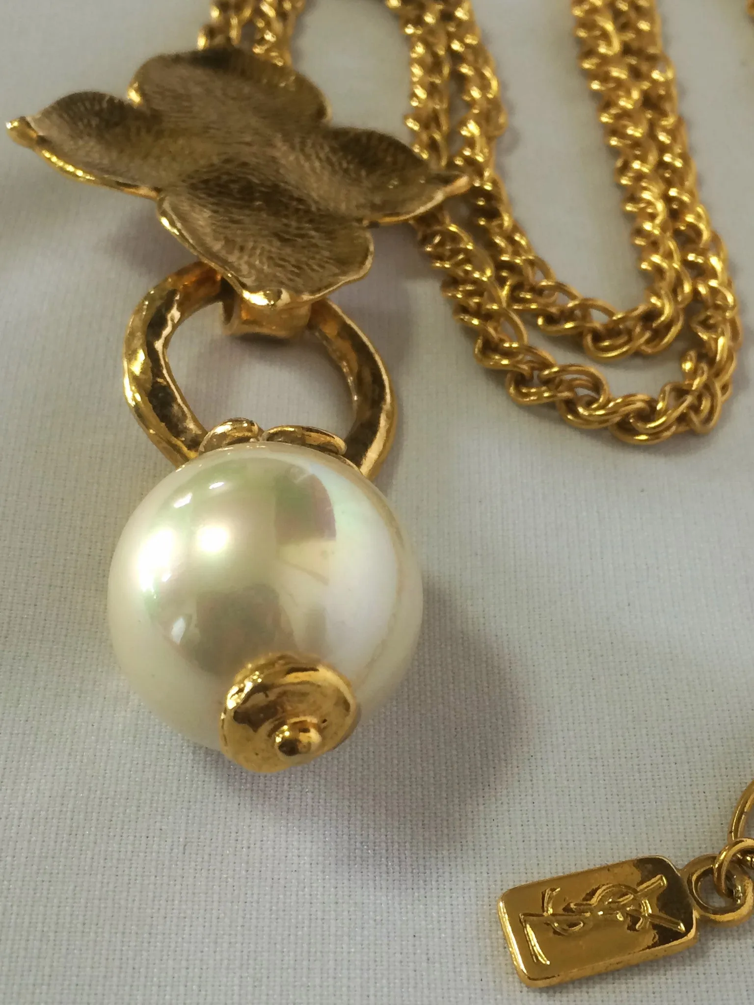 MINT. Vintage Yves Saint Laurent golden chain long statement necklace with extra large faux pearl and flower petal pendant top. Opal shine