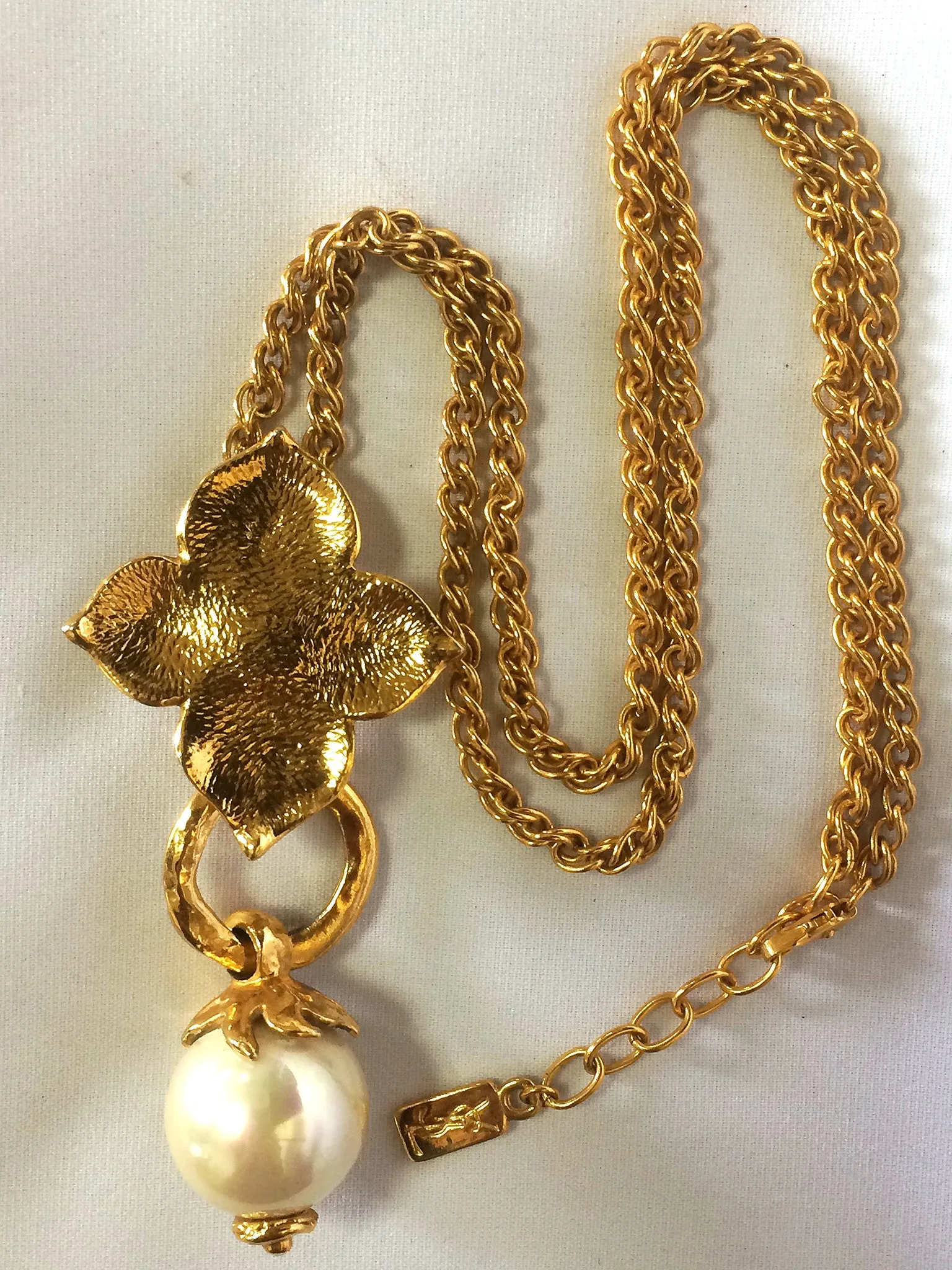 MINT. Vintage Yves Saint Laurent golden chain long statement necklace with extra large faux pearl and flower petal pendant top. Opal shine