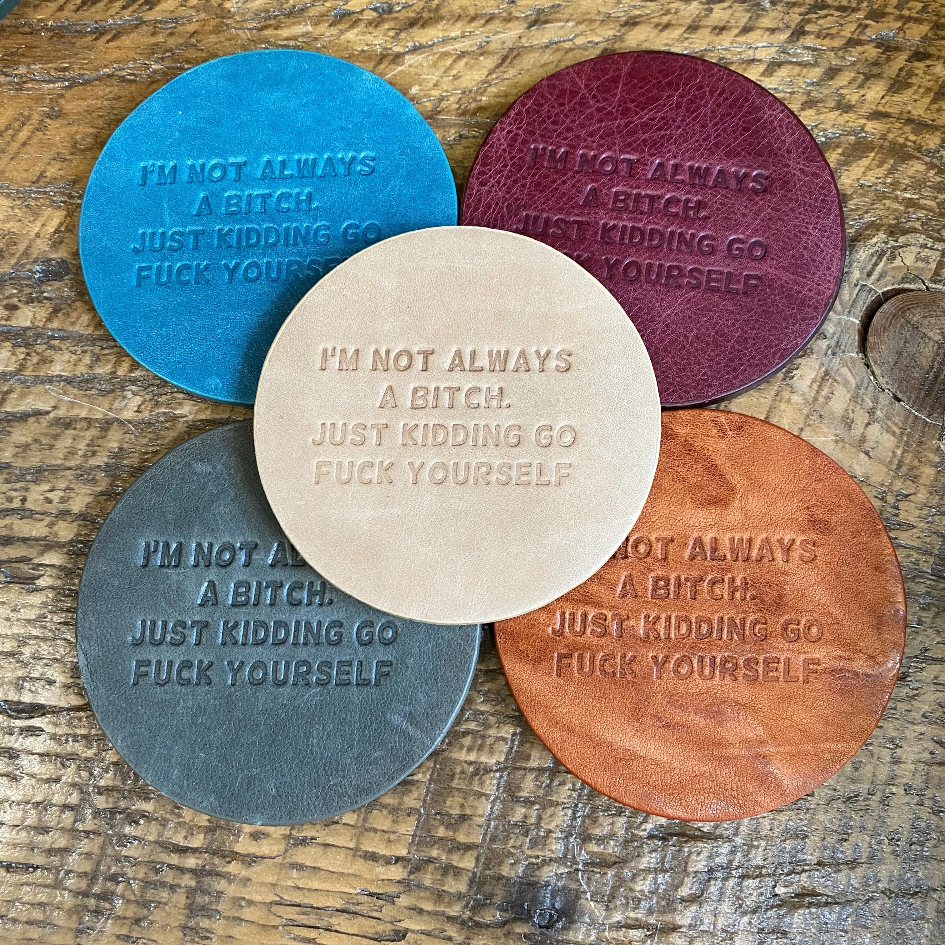 Snarky assorted color embossed leather coasters, sets of 5