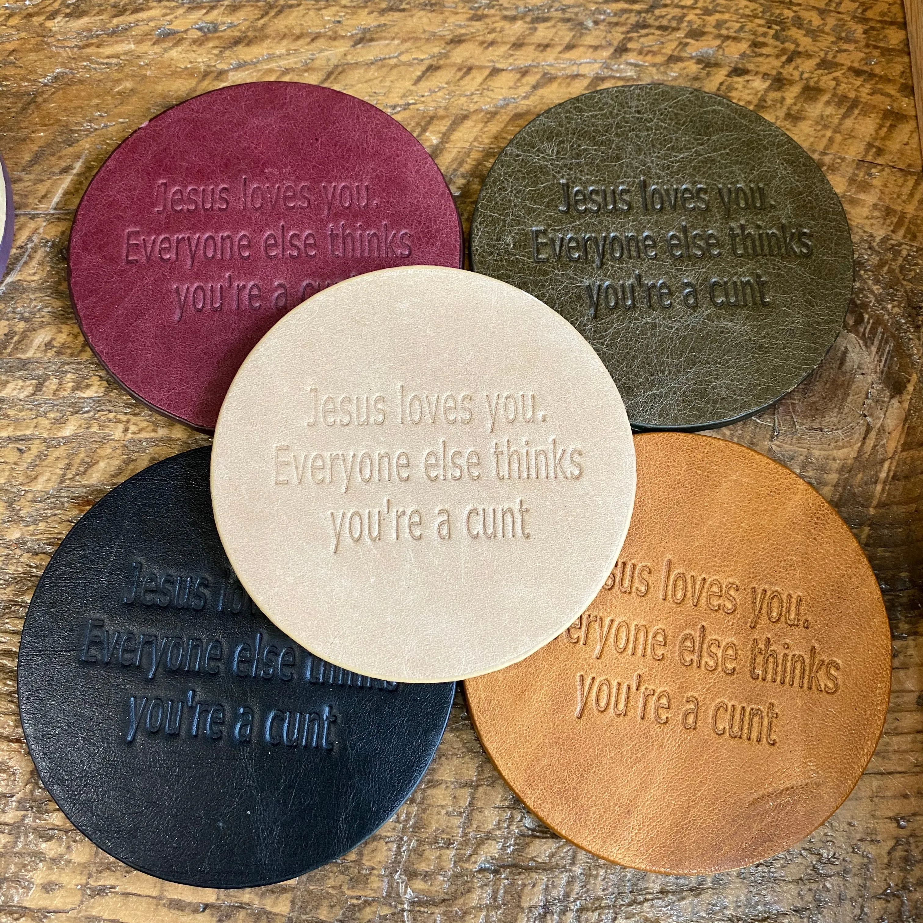 Snarky assorted color embossed leather coasters, sets of 5