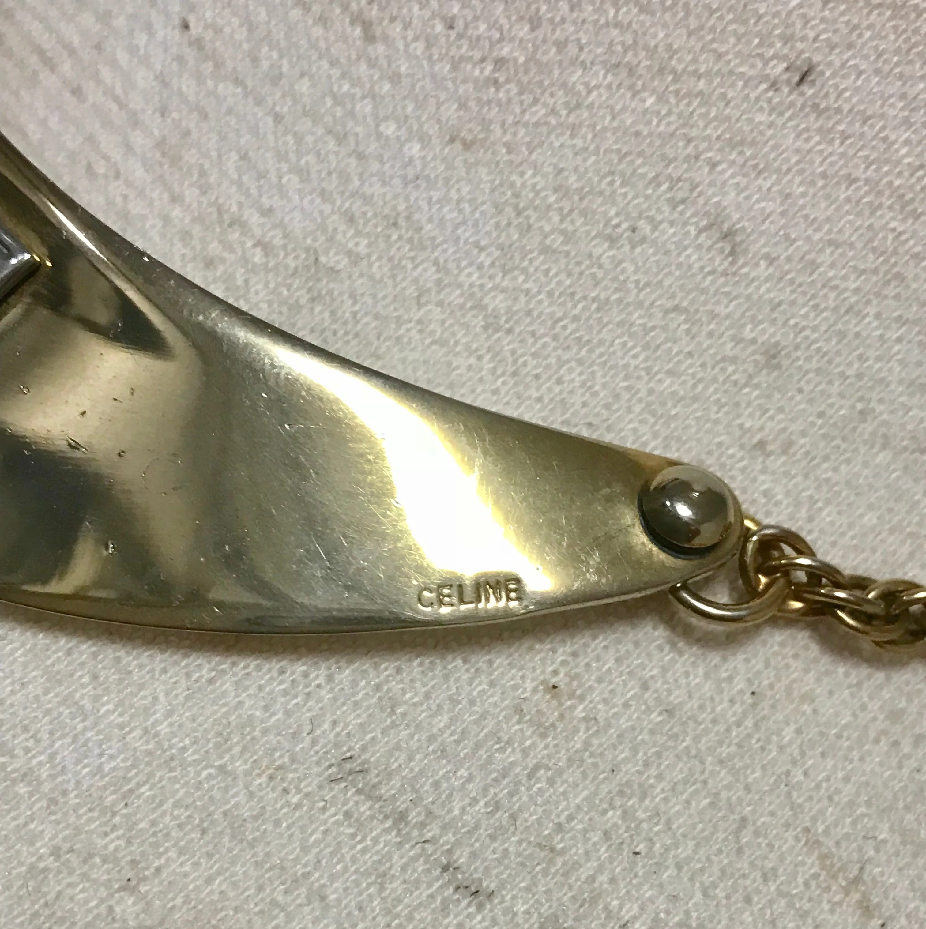 Vintage Celine gold tone crescent moon shape necklace with silver triomphe logo. 05062810