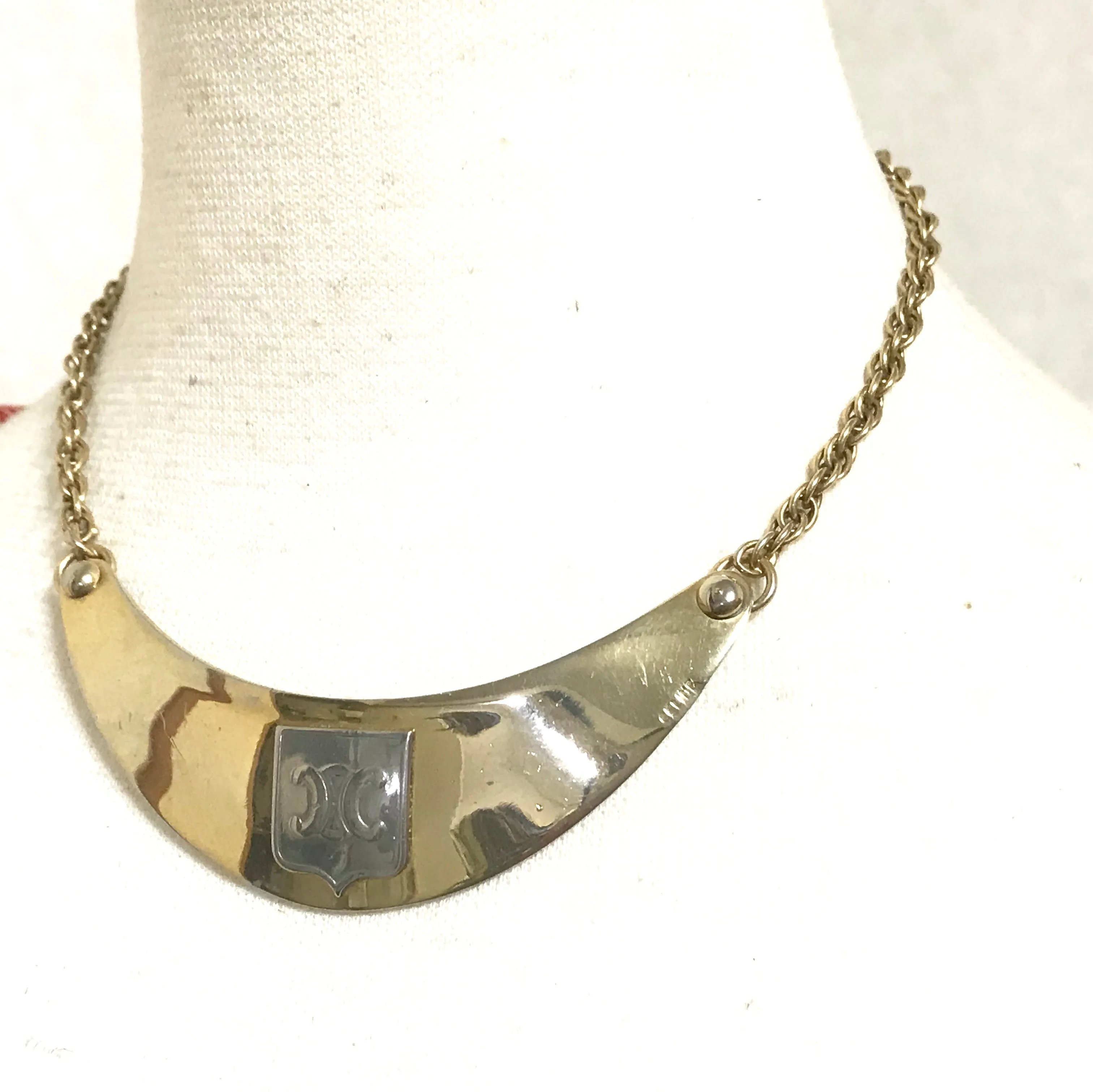 Vintage Celine gold tone crescent moon shape necklace with silver triomphe logo. 05062810