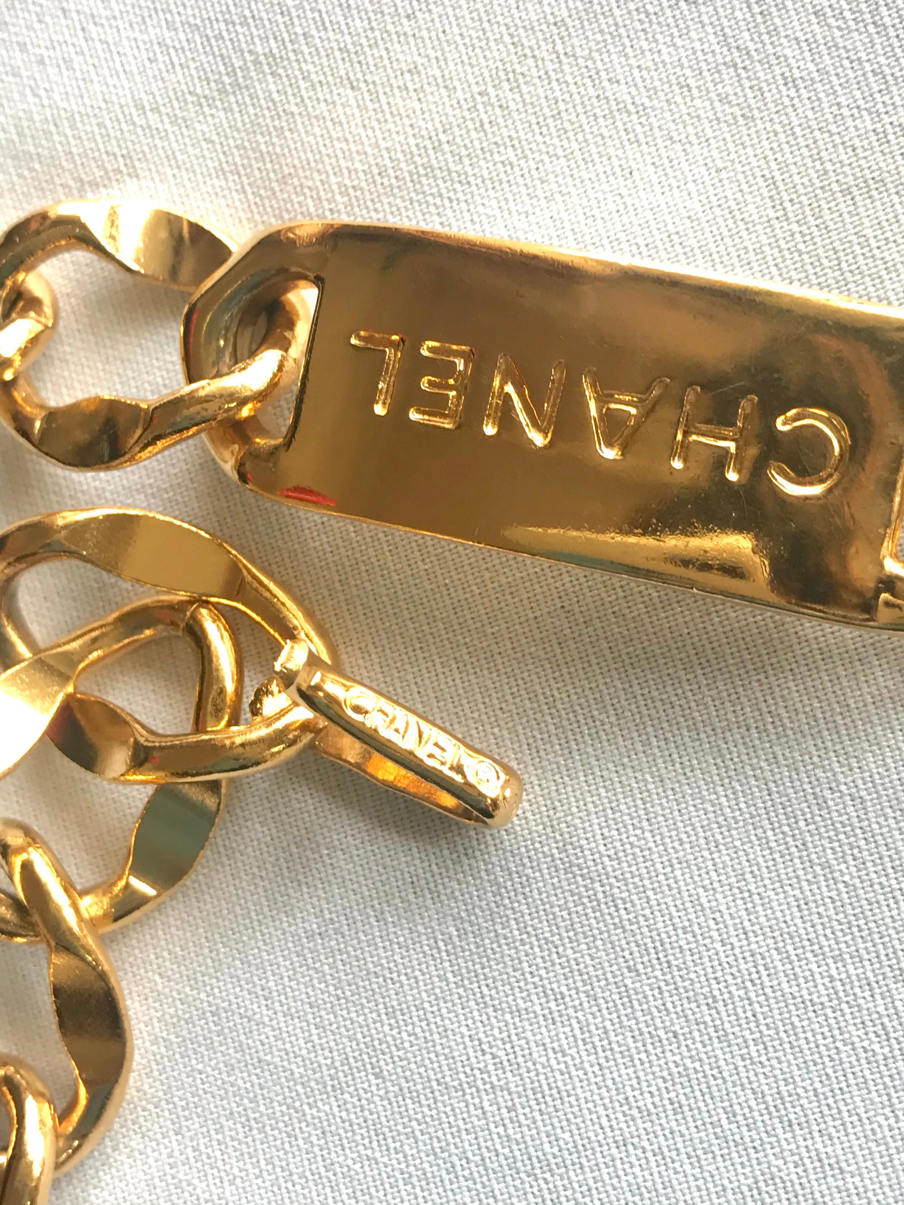 Vintage CHANEL golden thick chain belt with logo engraved bar motifs and a round charm to the end. Must have gorgeous accessory.
