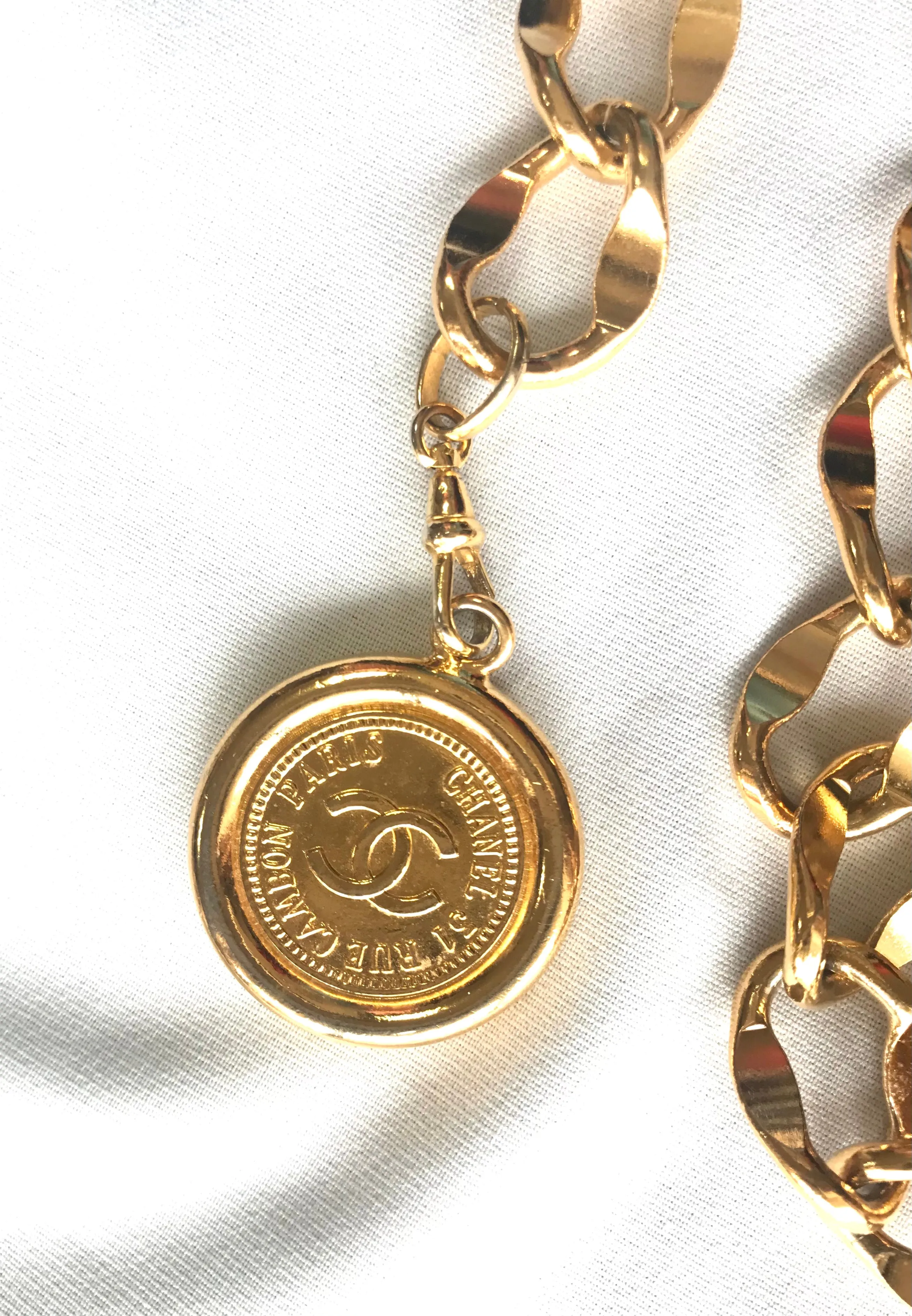 Vintage CHANEL golden thick chain belt with logo engraved bar motifs and a round charm to the end. Must have gorgeous accessory.