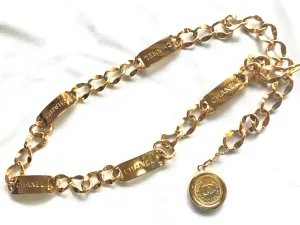 Vintage CHANEL golden thick chain belt with logo engraved bar motifs and a round charm to the end. Must have gorgeous accessory.